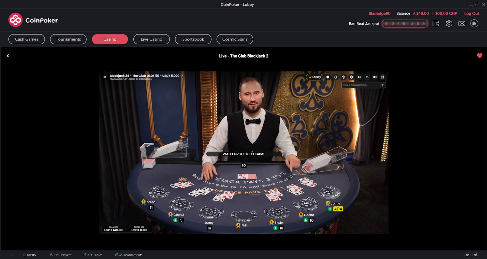 Live dealer blackjack at CoinPoker with the dealer holding a Queen and face down card, with six other player hands visible