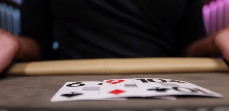 Three Blackjack cards seen up close, dealt by live blackjack dealer.